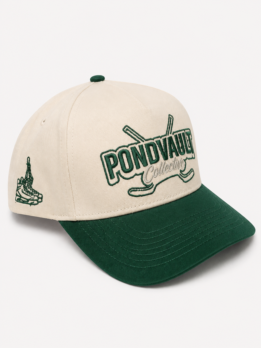An off-white baseball cap with a dark green visor, featuring 'PONDVAULT Collection' embroidered in green on the front with crossed hockey sticks behind it, and a small green hockey player graphic on the side.
